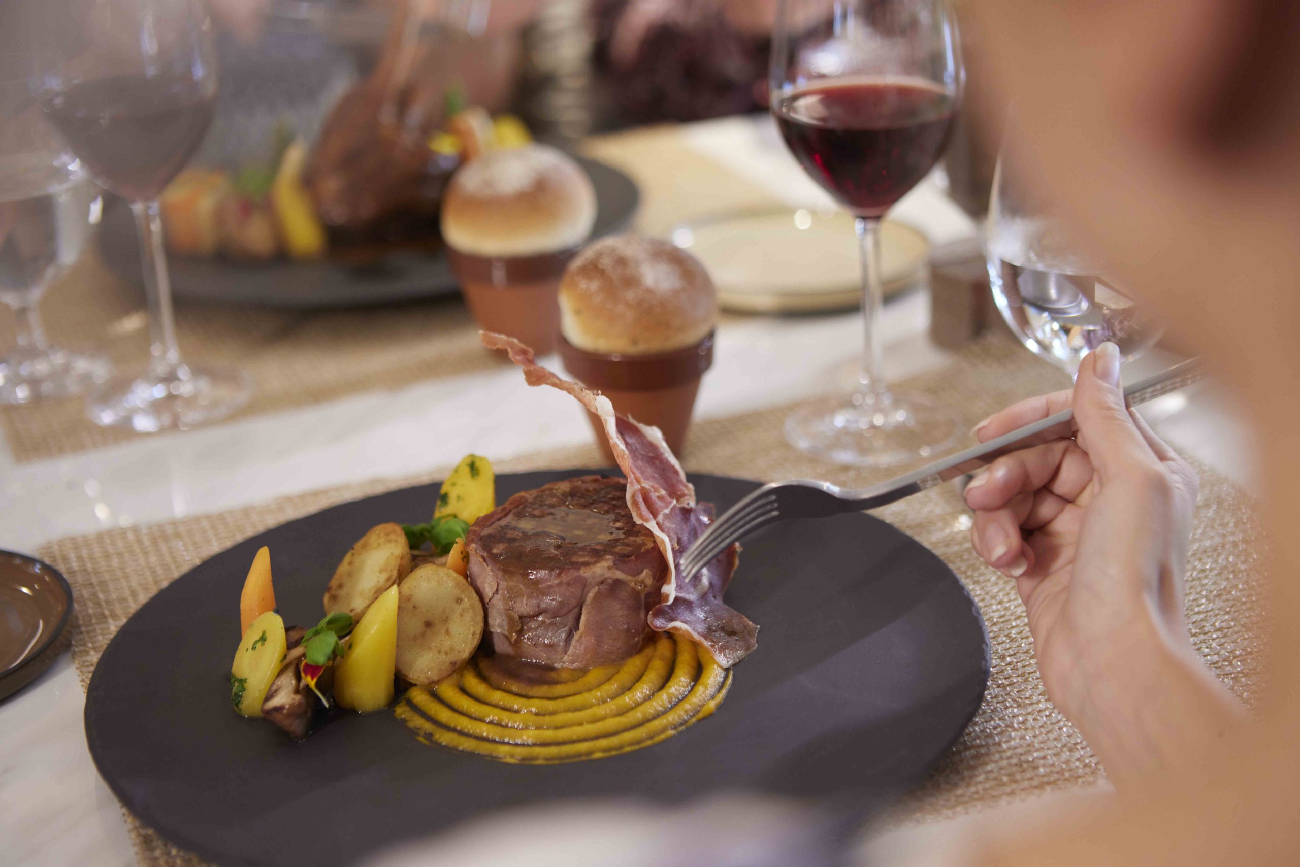 A guest eating one of the dishes of the SALT Kitchen.